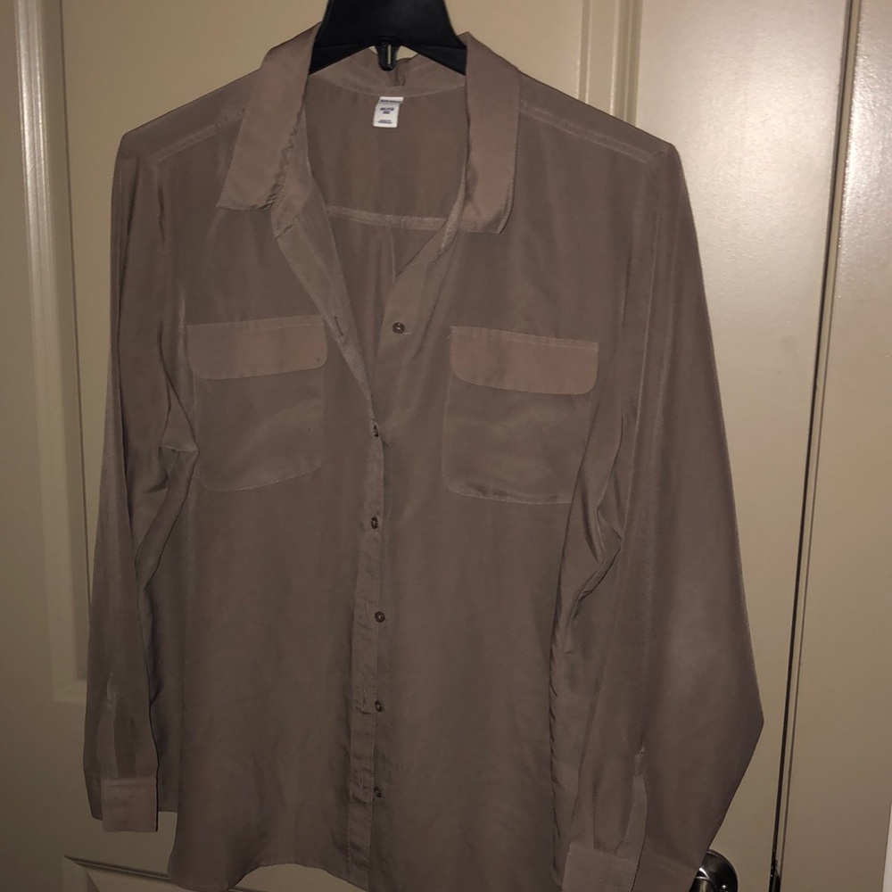 Tan button down shirt.